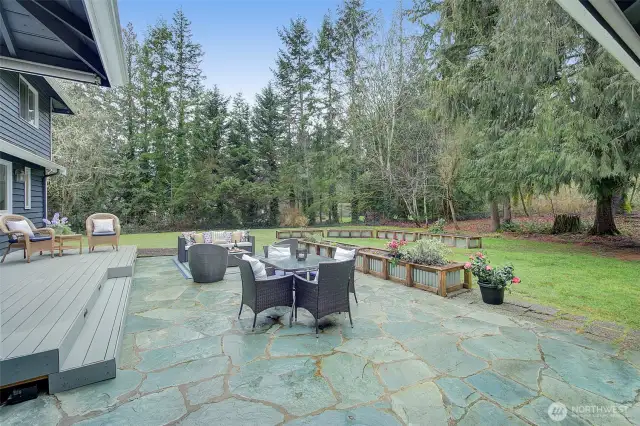 Relax or entertain on this luxurious deck and flagged patio.