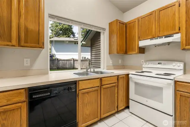 Double stainless sink. Solid counters with matching back splash.