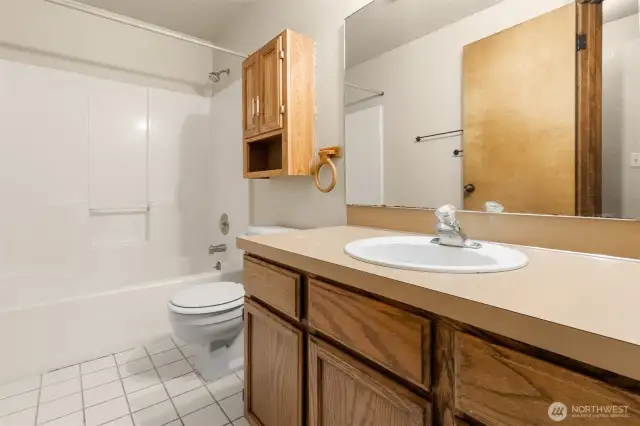 Full guest bathroom with shower/tub combo. Tile flooring.