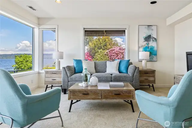 The lower-level family room with views of the colorful landscaping and the Sound.