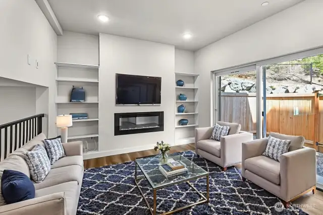 Living Area with Fireplace and Access to Backyard - Virtually Staged