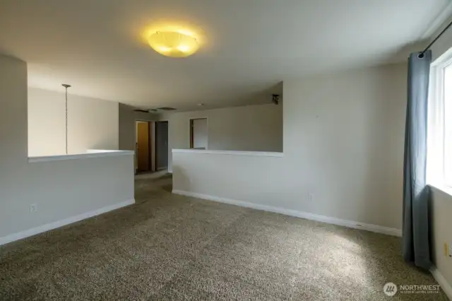 Upstairs, you'll find neutral wall-to-wall carpet and a large loft