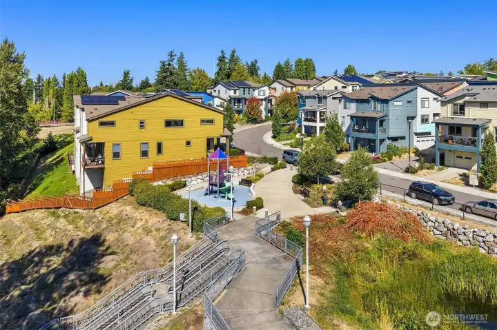 Playground area with stairs leading to a greenbelt path to White Center.