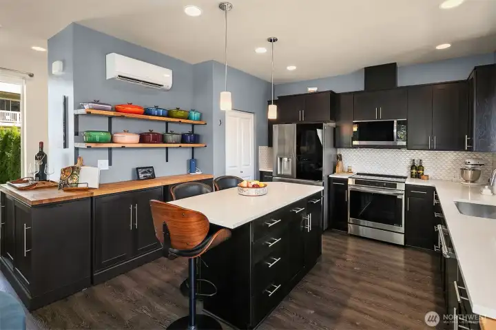 Custom cabinetry and shelving beautifully elevates the space and offers tons of additional storage. Note the ductless mini-split (one of three added).