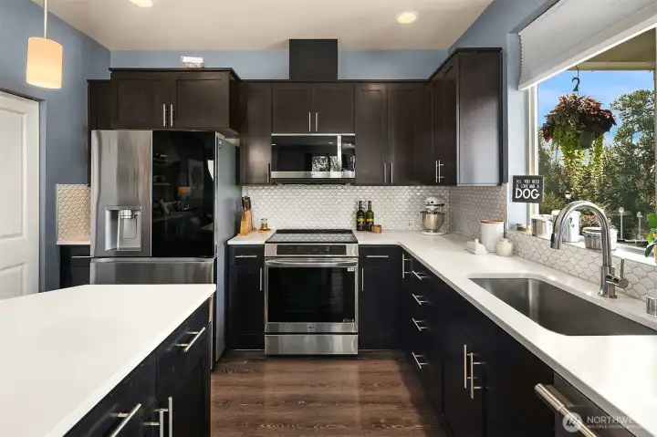 Elegant and light-filled, this kitchen will bring out the chef in you. And don't you love that timeless tile backsplash?
