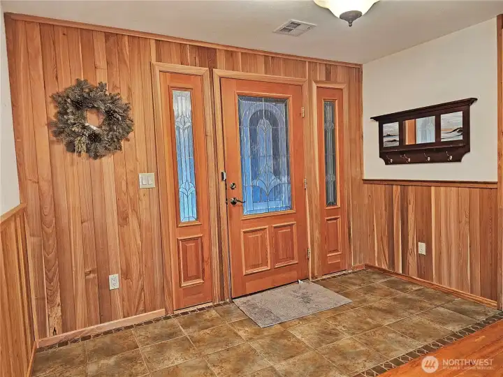 Looking at the front door from the inside. A nice tile entryway with pine interior creates a warm and welcome feel!