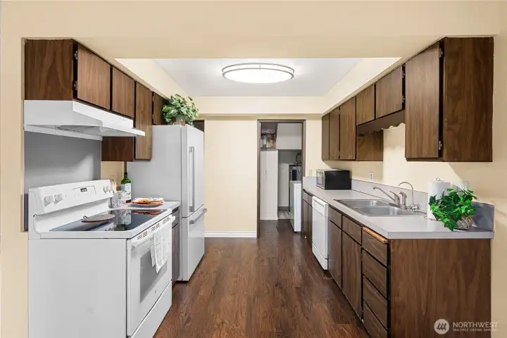 The galley kitchen is wide and sizable and leads to laundry area.