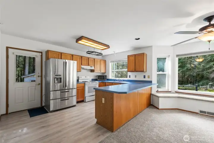 Functional kitchen with door to side yard.