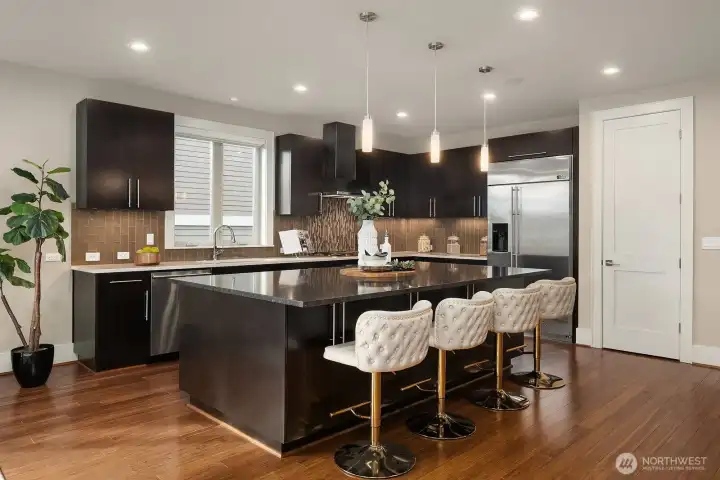 Chef's kitchen with GE Monogram appliance package and spacious walk-in pantry storage