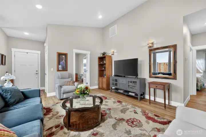 Offering valted ceilings, built in wall sconces and large picture windows. Allows for an abundance of natural light. Light gray accent walls with beautiful flooring thoughout the house.