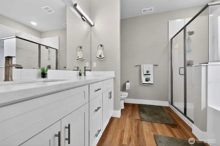 Main suite bathroom with full tub and seperate shower.