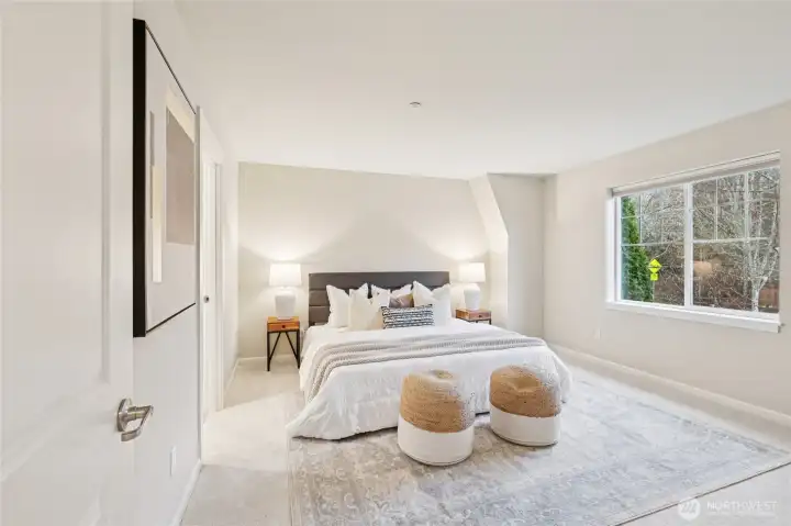 Large primary bedroom with ensuite bathroom, and walk in closet.