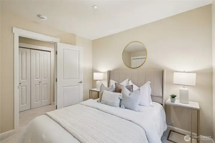 Bedroom with custom shelving in closet.