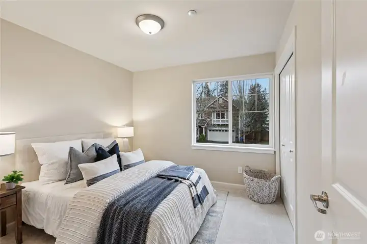 Bedroom with custom shelving in the walk in closet.
