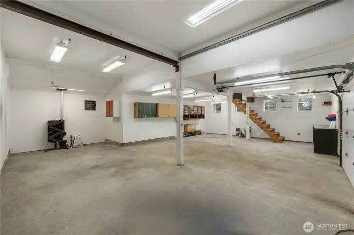 Another view of shop w/ pellet stove and stairs to loft area.