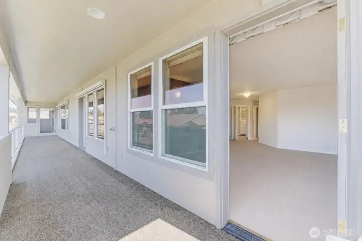 Doors off of deck with doors into den, living room, and dining room.