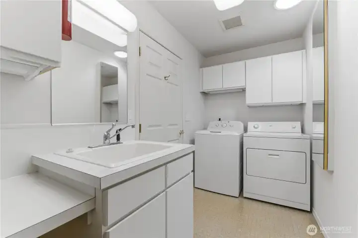 Laundry room with utility sink and craft space.