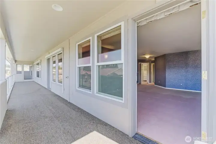 Doors off of deck with doors into den, living room, and dining room.