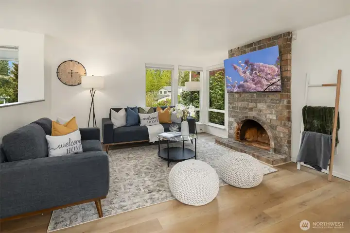Open concept living room with lots of natural light, updated fixtures and great flow into the kitchen/dining space