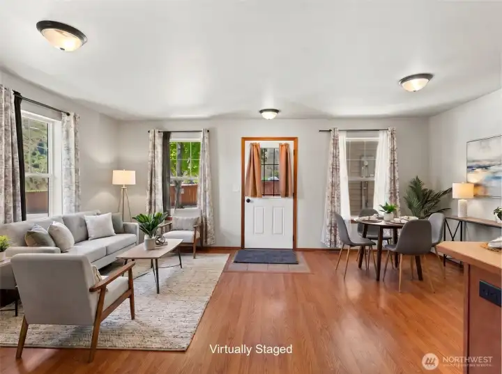 Virtually Staged - Open living room with excellent natural light and seamless flow to the kitchen, creating an ideal space for gathering and entertaining.