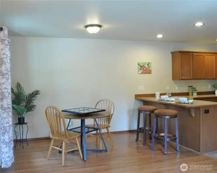 Open-concept kitchen and dining area designed for gathering, featuring abundant natural light and convenient seating options.