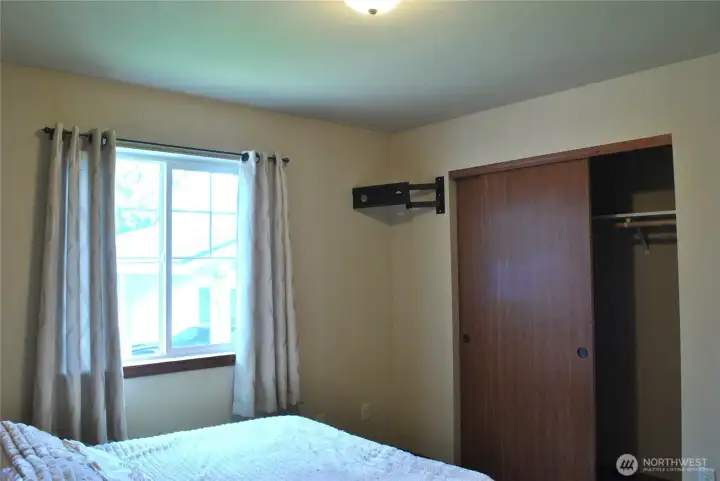 Bedroom with generous closet storage and large window providing excellent natural light.