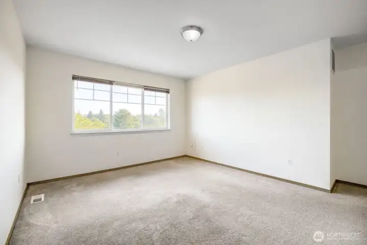 Nice sized primary bedroom with views and a walk-in closet!