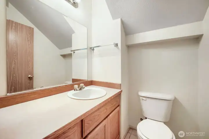 Half bath with extra storage on the main level. Convenient for to the media room.