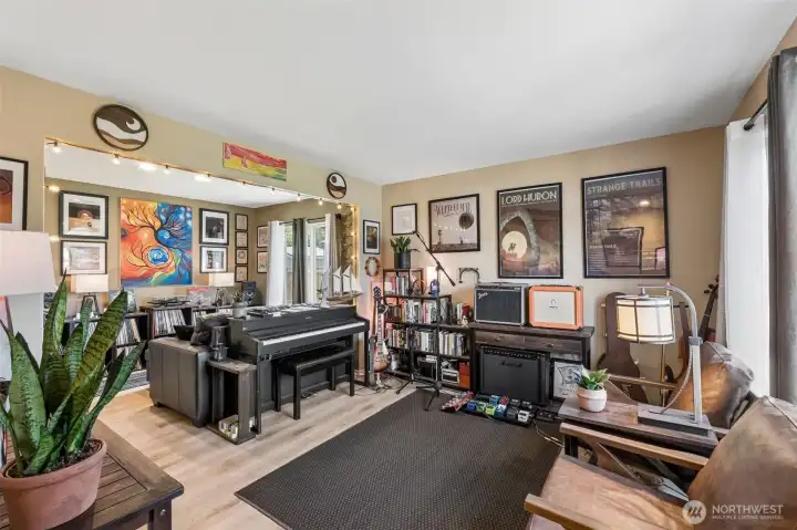 Front living room filled with natural light from large windows overlooking the front and backyard. Front living room filled with natural light from large windows overlooking the front and backyard.