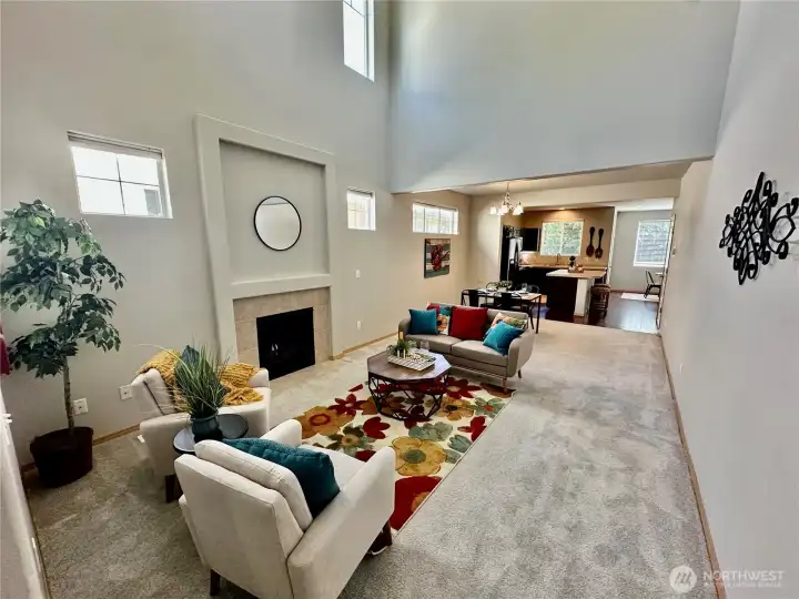 Light and airy living room with 2-story ceiling and clerestory windows providing natural light plus gas log fireplace with recessed wall niche above. Light and airy living room with 2-story ceiling and clerestory windows providing natural light plus gas log fireplace with recessed wall niche above.