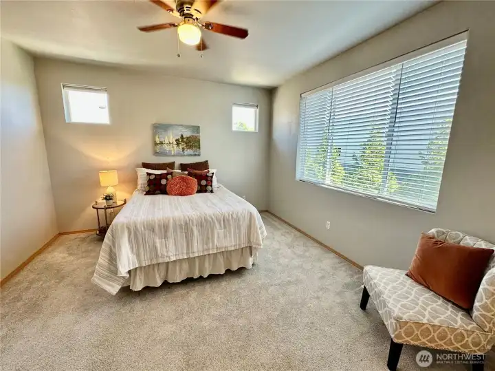 The upper floor primary bedroom features an ample walk-in closet, en-suite and ceiling fan. The upper floor primary bedroom features an ample walk-in closet, en-suite and ceiling fan.