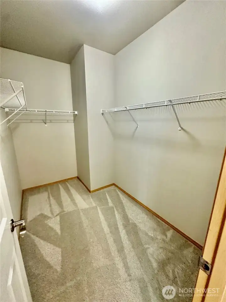 Primary walk-in closet. Primary walk-in closet.
