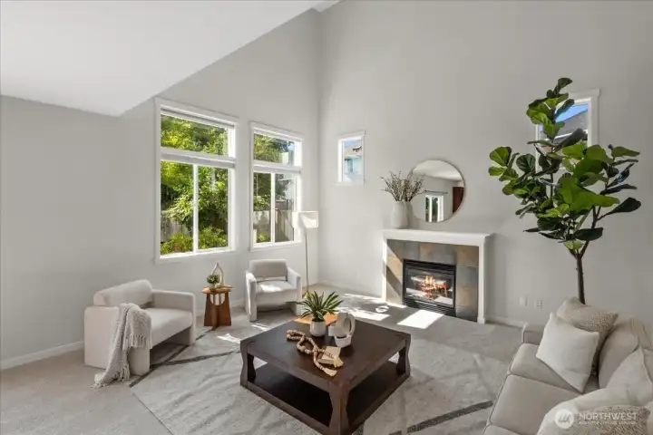 The family room features vaulted ceilings, a gas fireplace and the large windows flood the home with natural light.