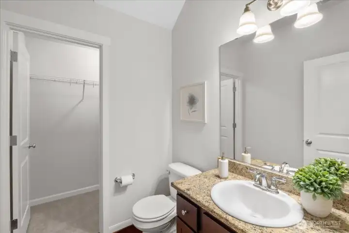 Main floor half bath also features a large walk-in closet for extra storage