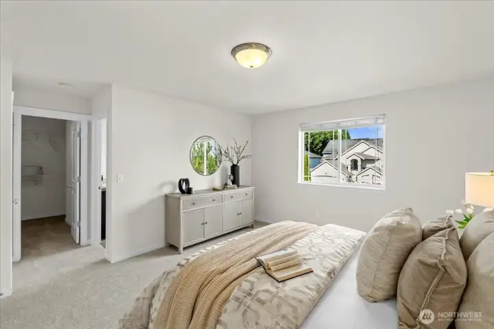 The primary suite features a large walk-in closet and en-suite full bathroom