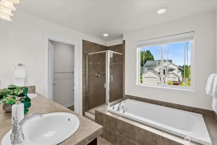 Soak in a warm bath after a long day in the privacy of your primary bedroom retreat