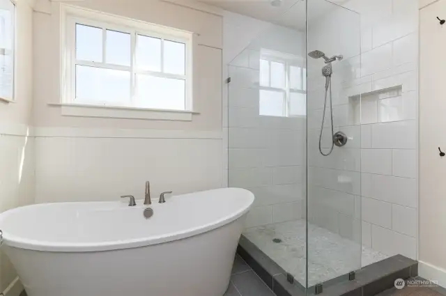 Primary bathroom's soaking tub and walk in shower