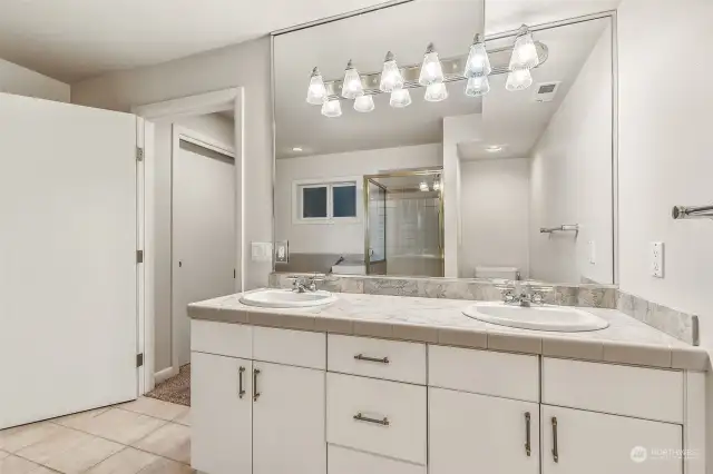 Primary 5 pc. bathroom with double sinks, soaking tub & full tile walk-in shower.