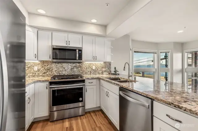 NEW stainless steel appliances, granite countertops & backsplash, white shaker cabinets & oooohhhh the view of the water while you are cooking meals!