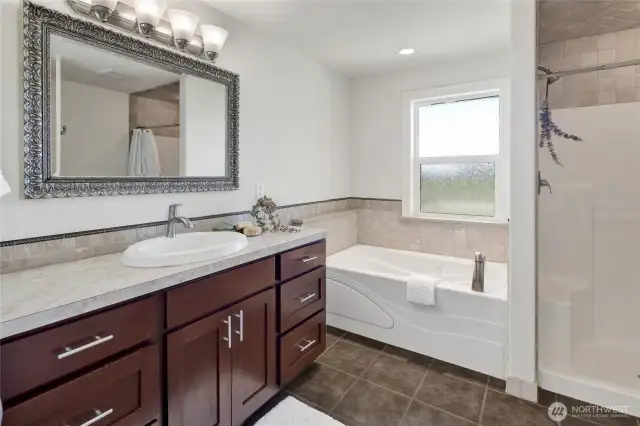 The primary bath features a soaker tub and separate shower