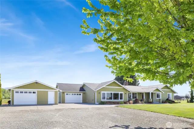 A fully updated 3-bedroom rambler with attached garage, detached garage, and 4-bay shop