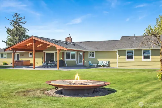 Imagine entertaining with this huge backyard complete with huge firepit, covered back patio, and hot tub!