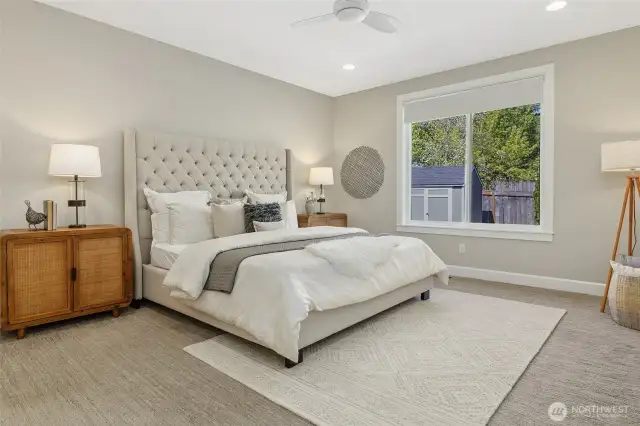 The spacious primary suite features a luxurious bath and an impressive closet.  The added convenience of a remote-controlled ceiling fan ensures personalized comfort year-round.