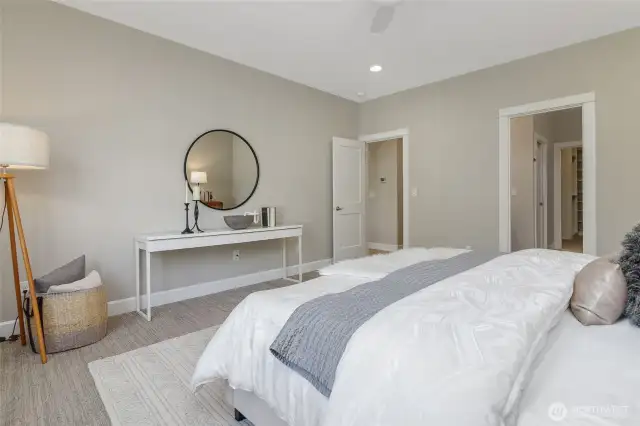 The spacious primary suite features a luxurious bath and an impressive closet.  The added convenience of a remote-controlled ceiling fan ensures personalized comfort year-round.