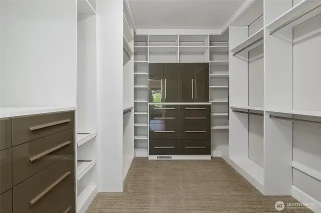The custom California Closet is a marvel of organization, featuring a personal safe, a convenient pull-out rotating full-length mirror, valet bars, dedicated tie and belt holders, and easily accessible pull-out shelving.