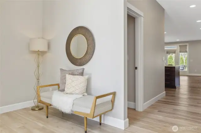 The impressive 12-foot entryway, adorned with a hand-forged chandelier, also offers the rare amenity of a double-sized closet, creating an unforgettable foyer.