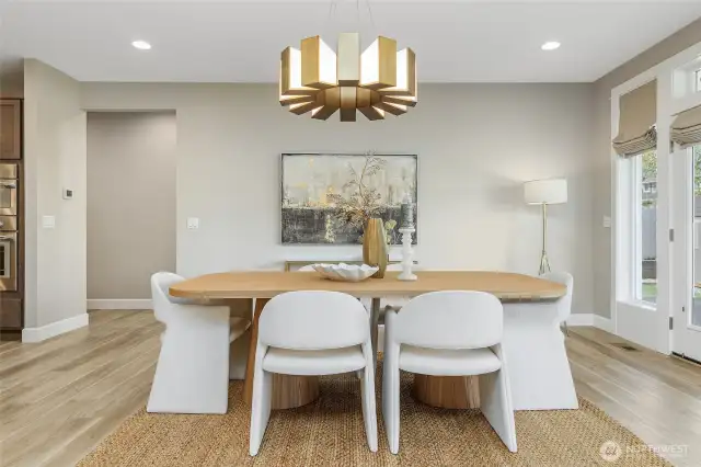 The dining room is graced by a stunning lighting fixture, truly a work of art that elevates the entire space.