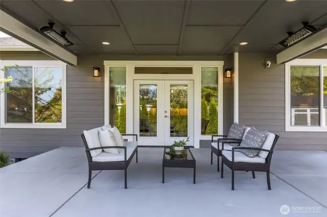 Extend your living outdoors year-round on the covered patio, equipped with built-in Infratech heaters for chilly evenings, a convenient natural gas hookup for your BBQ, and pre-wired for additional lights, speakers or a TV, making it ideal for entertaining and relaxation.