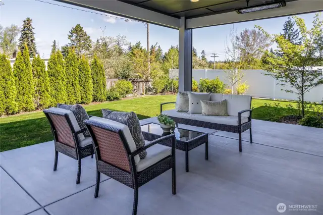 The one-story living extends to the covered patio, complete with heaters for cool evenings, a convenient plumbed gas line for grilling, ambient lighting, and plentiful space for gardening.