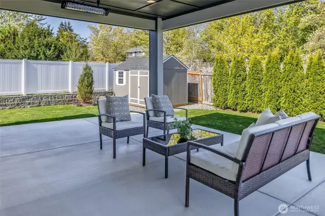 The exterior features professional landscaping, a sprinkler system, a new retaining wall, maintenance-free white vinyl fencing, and a Yardline 8’ x 12’ storage shed.